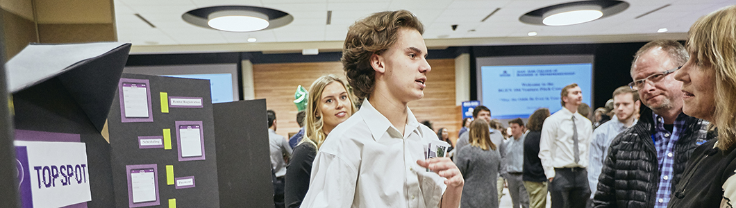 Students presenting at a poster session 