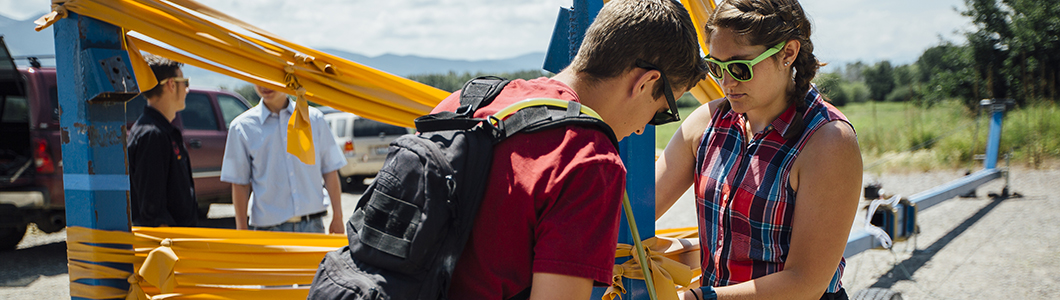 Students double-check the apparatus on an outdoor experiment.