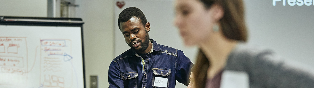 A group of young men discuss a group project.