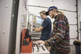 two male students working on a mechanical project