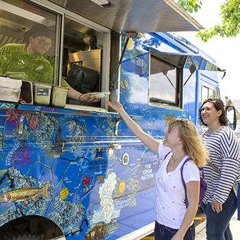 picture of two girls ordering food at a food truck