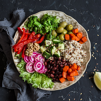 mixed veggie platter with broccoli, green olives, beans, cucumber and red peppers