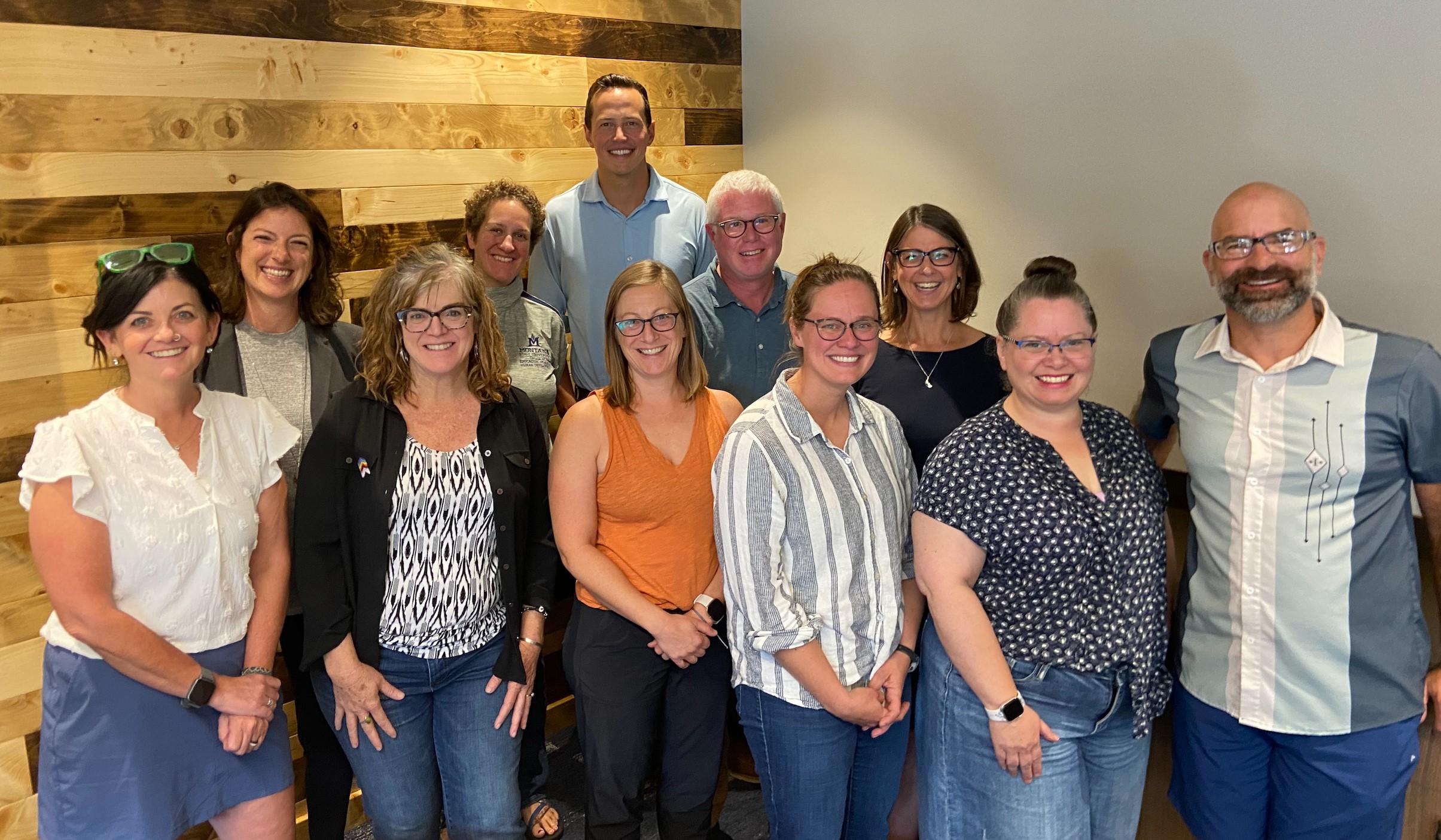 Image, ten Academic Diversity Partners standing in two rows, smiling and looking at the camera