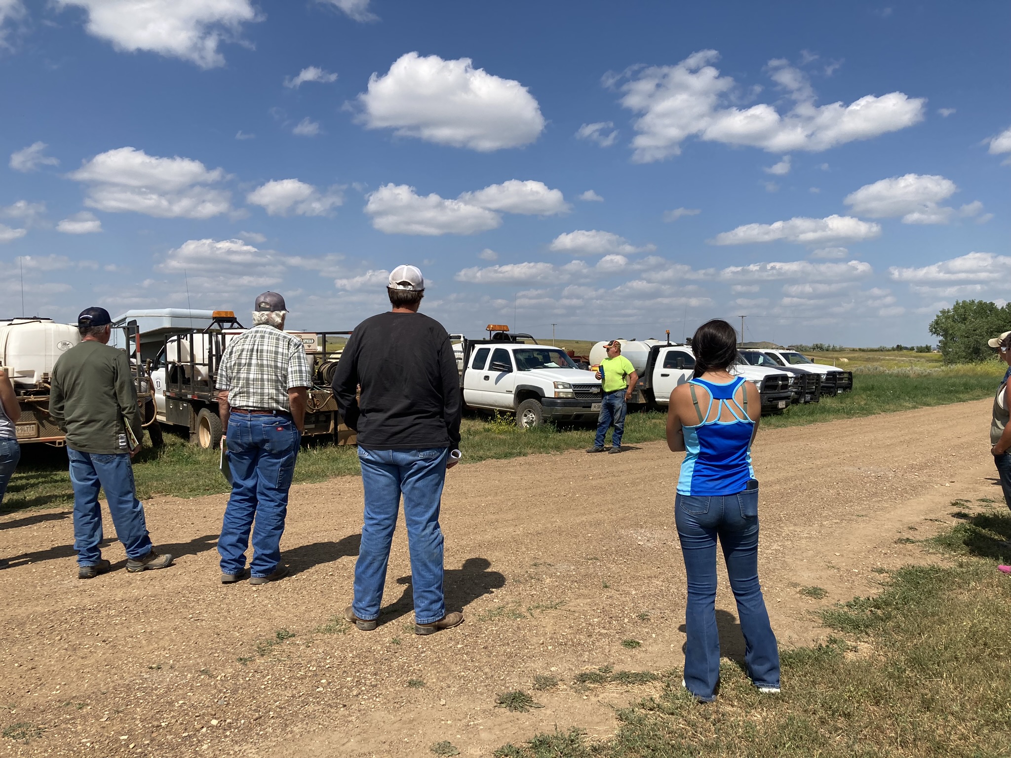 Tri-County tour participants learn about equipment calibration from Prairie County Weed Coordinator Travis Lacquement