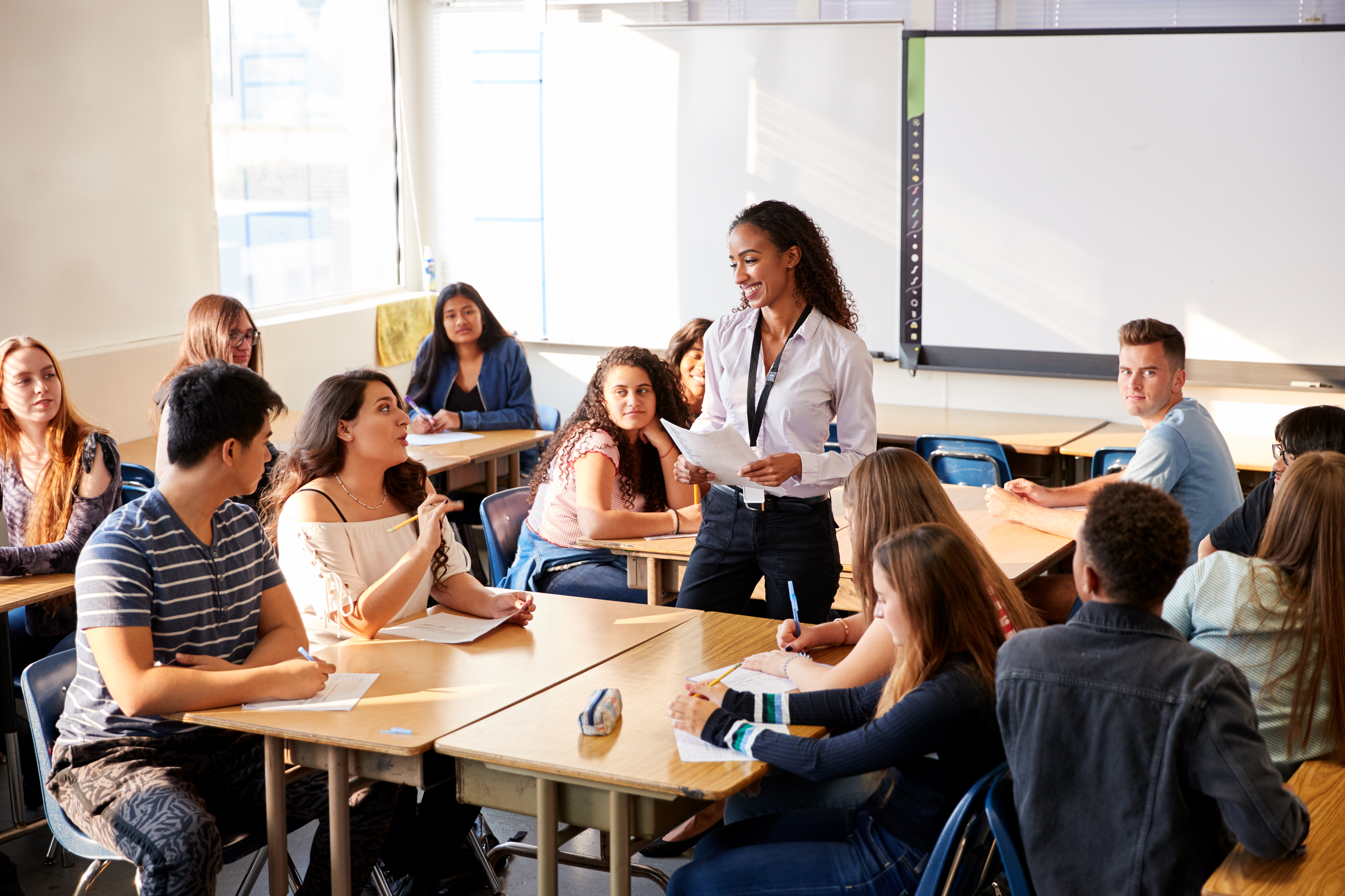 Students and a teacher in a classroom.