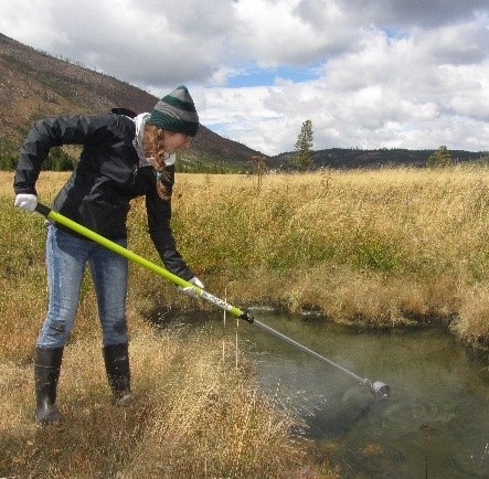 Woman samples pool at Yellowstone