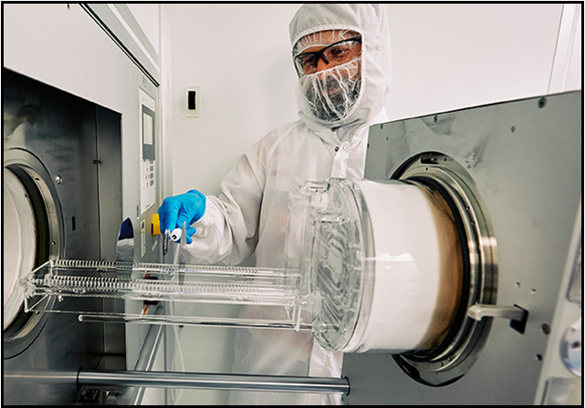 person in PPE working in lab