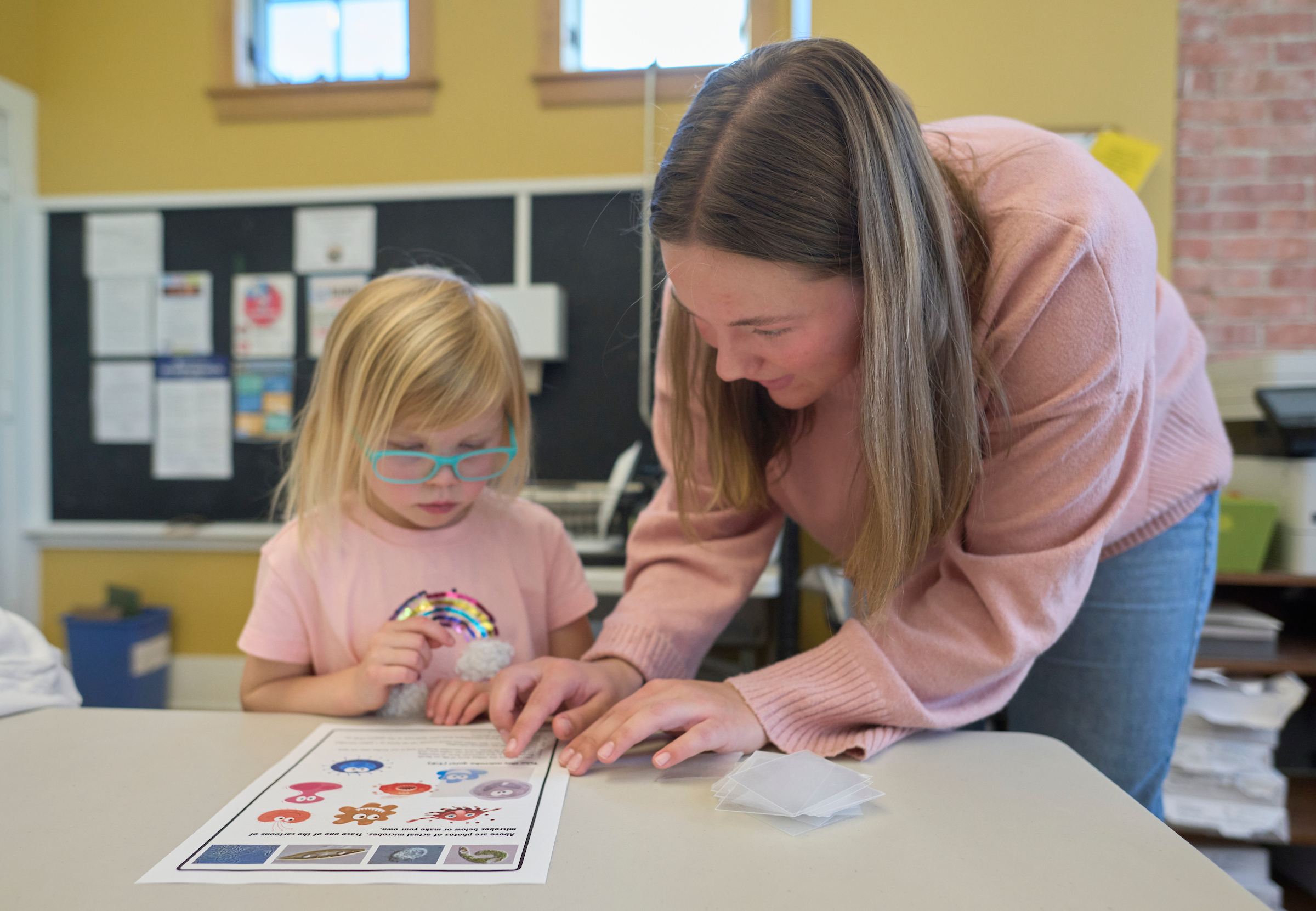 teacher and child at table