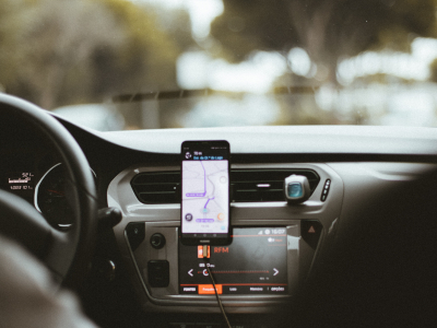 A car dash with a phone navigating